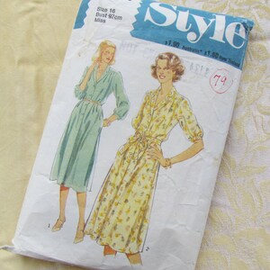 May include: A vintage sewing pattern for dresses, labelled "Style". The pattern shows illustrations of two dresses, one green and one yellow floral print. The pattern includes sizing information: Bust 97cm, Size 16. The cover is slightly worn.