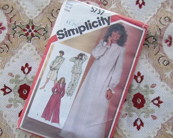 May include: A vintage Simplicity sewing pattern packet, featuring illustrations of sleepwear designs. The packet is red and white, with the Simplicity logo prominently displayed. The pattern includes options for a nightgown, pajamas, and a robe.