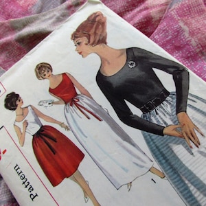 May include: Vintage sewing pattern for a dress with a white skirt and a black top. The pattern number is 5533, size 16, bust 36. The pattern shows three different styles of dresses.