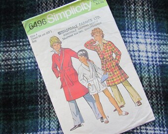 May include: Simplicity sewing pattern number 6496 for a boy's robe. The pattern includes three different robe styles, one red, one white, and one plaid. The pattern is for a chest size of 58 cm (23 inches).