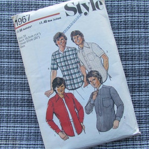 May include: A sewing pattern for four different shirts. The pattern is from 1967 and is called "Style" with the word "Exchangeable" printed on the cover. The pattern includes instructions for making shirts with different collar styles and sleeve lengths.