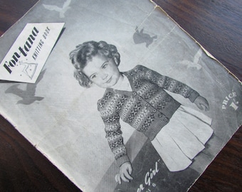 May include: A vintage knitting pattern book cover featuring a young girl wearing a white and grey sweater with a snowflake design. The cover also features the title "Fontana Knitting Book" and the price "1/-."