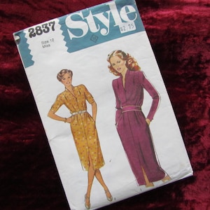 May include: Vintage Style sewing pattern with illustrations of two dresses. The pattern cover has the number 2837, size 12 Miss, and the word "Style" in a blue and white design. The background is a deep red.