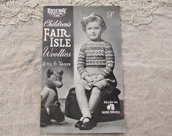 May include: Black and white vintage book cover titled "Children's Fair Isle Woollies" featuring a young girl in a patterned sweater and a teddy bear. The cover also includes the text "2 to 6 Years".
