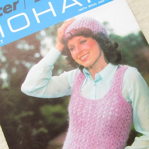 May include: A vintage crochet pattern booklet featuring a woman wearing a pink crocheted vest and a white crocheted hat. The cover of the booklet is blue and features the text "Lister Tahiti Mohair Crochet".