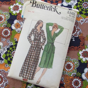 May include: A vintage sewing pattern for a long robe with a plaid print and a solid green robe. The pattern is from Butterick and is size 10. The pattern number is 5165 and the price is £1.50.