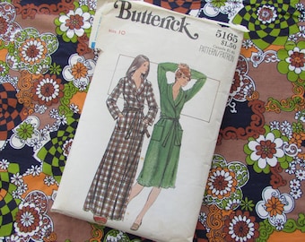 May include: A vintage sewing pattern for a long robe with a plaid print and a solid green robe. The pattern is from Butterick and is size 10. The pattern number is 5165 and the price is $1.50.