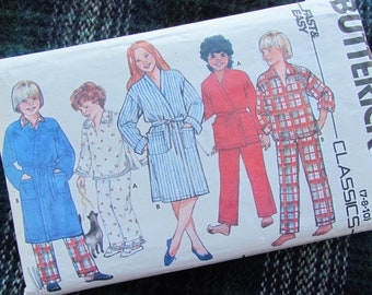 May include: A sewing pattern for making children's robes and pajamas. The pattern includes instructions for making a blue robe, a red robe, a floral print pajama set, and a plaid pajama set. The pattern is from the company Butterick and is labeled "Classics 178-101".