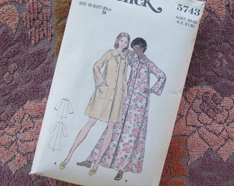 May include: Vintage sewing pattern for a long-sleeved robe with a collar. The pattern is for size 12 bust, 87 cm or 34 inches. The pattern shows two models wearing the robe, one in a solid beige color and the other in a floral print. The pattern number is 5743. The price is $2.00 in Australian dollars and $1.60 in New Zealand dollars.