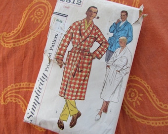May include: Vintage Simplicity sewing pattern for a men's robe. The pattern is for a robe with a plaid pattern and a white robe. The pattern is labeled "Simplicity Printed Pattern" and "Small".