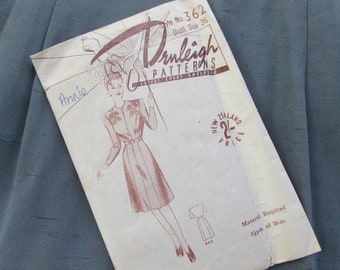 May include: A vintage sewing pattern for a dress, labeled "Style No. 362" and "Bust Size 36". The pattern is from "Drnleigh Patterns" and includes a layout chart. The pattern is for a dress with a fitted bodice and a full skirt. The pattern is printed on a white paper with brown ink. The pattern is in good condition, with some minor wear and tear.