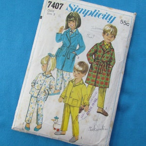 May include: Simplicity sewing pattern number 7407 for children's robes. The pattern includes four different robe designs: a blue robe with a white collar, a plaid robe, a yellow robe, and a floral robe. The pattern is for sizes 3.
