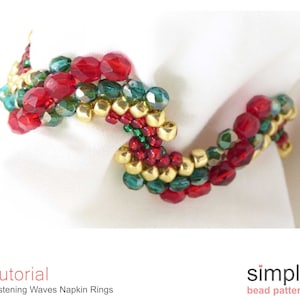 May include: A beaded napkin ring in red, green and gold. The beads are arranged in a wavy pattern. The napkin ring is on a white fabric background. The text "Tutorial" and "Glistening Waves Napkin Rings" is below the image. The text "simple bead patterns" is below the image.