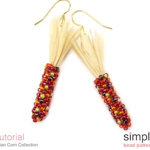 May include: A pair of beaded corn earrings with gold hooks and a raffia tassel. The corn is beaded in red, orange, and yellow.