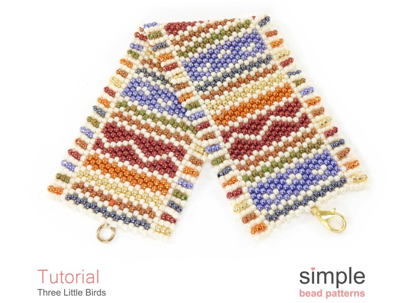 May include: A colourful beaded bracelet with a geometric pattern in shades of red, orange, yellow, green, blue, and white. The bracelet has a gold clasp.