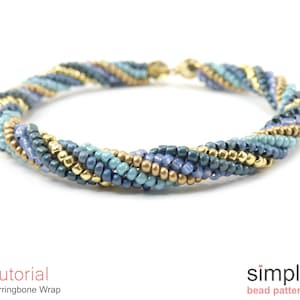 Könnte beinhalten: Ein blaues, goldenes und türkisfarbenes Armband aus Perlen, hergestellt mit einem Fischgrätenmuster. Das Armband ist verdreht und hat einen einfachen Verschluss.