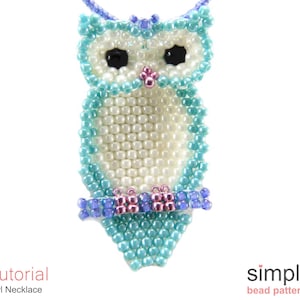 May include: A beaded owl necklace with a white body, turquoise wings, and purple accents. The owl is perched on a branch.