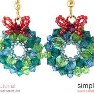 May include: A pair of green and blue crystal beaded earrings with red bows. The earrings are shaped like wreaths and are a festive holiday design.