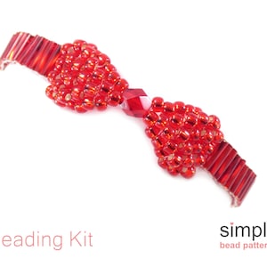 May include: Red beaded bracelet with two heart-shaped bead clusters and a crystal bead in the center. The bracelet is made with red seed beads and a red crystal bead. The bracelet is a DIY kit from simple bead patterns.