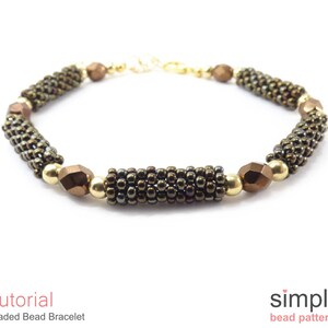 May include: A beaded bracelet with brown and gold beads. The bracelet is made with small seed beads and larger faceted beads. The bracelet is closed with a gold clasp.