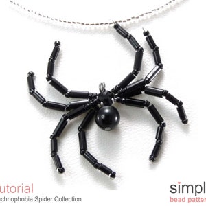 May include: Black beaded spider pendant necklace. The spider is made of black beads and has a black bead for a body. The necklace is on a silver chain.