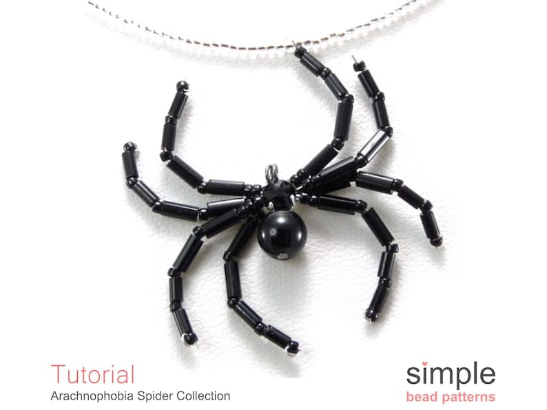 May include: Black beaded spider pendant necklace. The spider is made of black beads and has a black bead for a body. The necklace is on a silver chain.