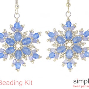 May include: A pair of snowflake-shaped earrings. Each earring features a central design of light blue oval beads surrounded by smaller, lighter blue and silver beads. The earrings are suspended from silver hooks. The text "Beading Kit" and "simple bead patterns" are visible.