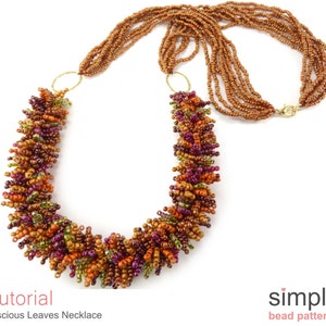 May include: A multi-strand necklace with a beaded pendant made of small, colorful beads in shades of orange, brown, green, and purple. The pendant is shaped like a cluster of leaves. The necklace is made of small, brown beads. The necklace is called "Luscious Leaves Necklace".
