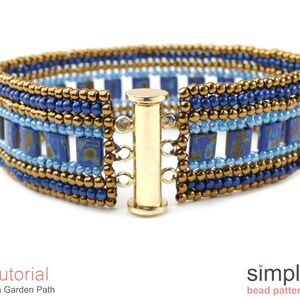 May include: A blue and gold beaded bracelet with a toggle clasp. The bracelet features a geometric pattern with square beads.