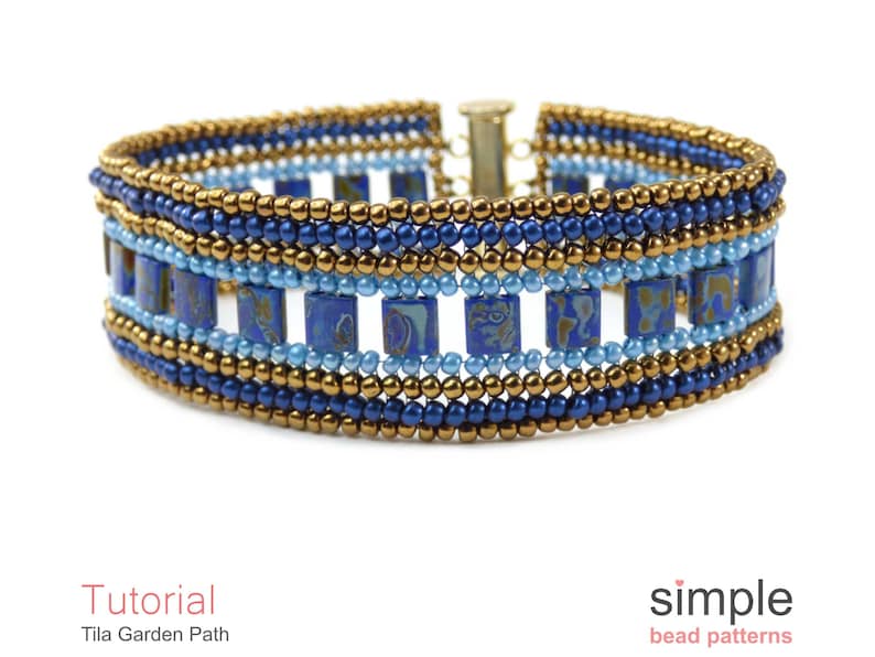 May include: A beaded bracelet with a gold, blue and light blue colour scheme. The bracelet features a repeating pattern of square beads and round beads. The bracelet is made with a clasp closure.
