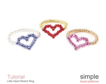 May include: Three beaded stretch rings with heart shapes. The rings are in red, purple, and pink.