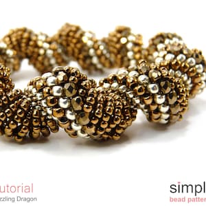 May include: A close-up of a gold and silver beaded bracelet with a spiral design. The bracelet is made with small, round beads and has a shiny finish.