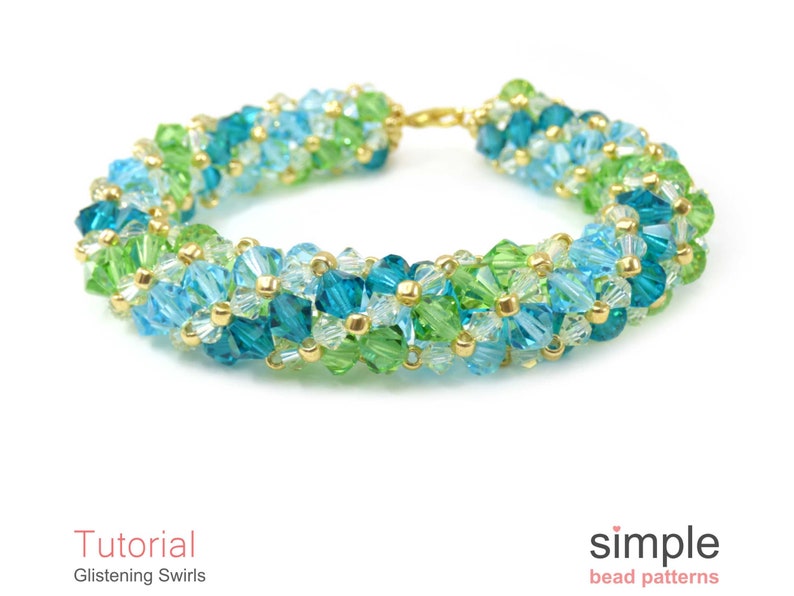 May include: A beaded bracelet with a gold clasp, featuring a swirling pattern of green, blue, and clear beads.