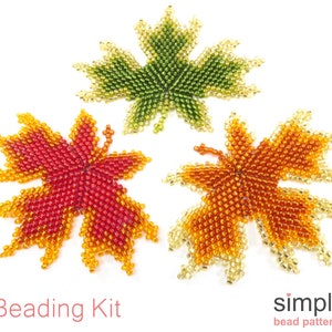 May include: Three beaded maple leaf ornaments in red, orange, and green. The leaves are made with seed beads and are a craft project.