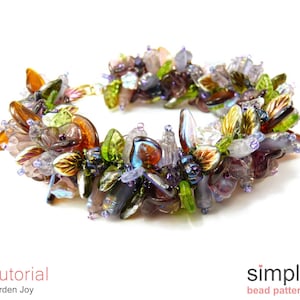 以下が含まれることがあります： 花柄のカラフルなビーズブレスレット。ブレスレットは、紫、緑、茶色、金色のさまざまなガラスビーズで作られています。ビーズは、葉と花のクラスターに配置されています。