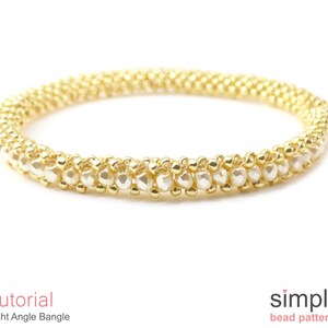 May include: A gold and white beaded bangle bracelet. The bracelet is made with small, round beads and is a simple design.