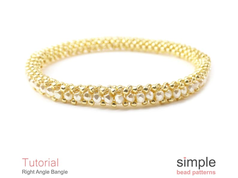 May include: A gold and white beaded bangle bracelet. The bracelet is made with small, round beads and is a simple design.