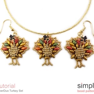 May include: A gold necklace and earrings set featuring a beaded turkey design. The turkey is made with gold, green, orange, and red beads. The necklace and earrings are a great way to add a touch of fall to your outfit.