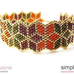 May include: A colourful beaded bracelet with a tessellated pattern in shades of gold, orange, green, and purple. The bracelet is made with small seed beads and has a wavy, scalloped edge.