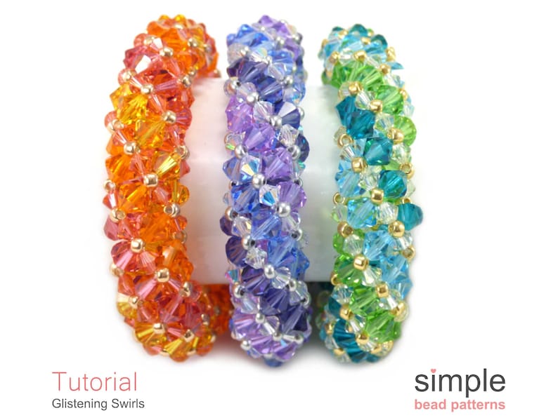 May include: Three beaded bracelets in a rainbow of colors. The bracelets are made with small, faceted beads in shades of orange, purple, and green. The bracelets are arranged in a row, with the orange bracelet on the left, the purple bracelet in the middle, and the green bracelet on the right. The bracelets are all made with the same pattern, which creates a swirling effect. The text "Tutorial: Glistening Swirls" is at the bottom left of the image, and the text "simple bead patterns" is at the bottom right of the image.