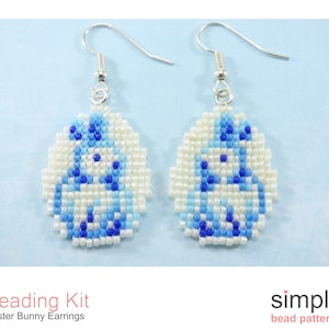 May include: A pair of blue and white beaded earrings shaped like Easter bunnies. The earrings are made with seed beads and are attached to silver ear wires. The earrings are part of a beading kit.