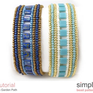 May include: Two beaded bracelets, one with blue and gold beads and the other with turquoise, white, and gold beads. The bracelets are stacked on top of each other. The text "Tutorial Tila Garden Path" is below the bracelets.