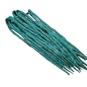 May include: A bundle of teal blue dreadlock extensions. The extensions are made of synthetic hair and are ready to be installed.