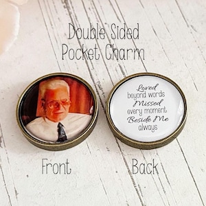 May include: Double-sided pocket charm with a photo of a man on one side and the text "Loved beyond words Missed every moment Beside Me always" on the other side.