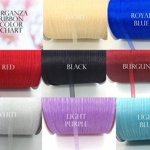 May include: A color chart of organza ribbon in various colors, including ivory, royal blue, red, black, burgundy, white, light purple, and light blue. The chart is labeled "Organza Ribbon Color Chart".