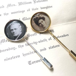 May include: Two vintage style photo pins with silver and gold pins. The pins feature round glass cabochons with black and white photos of a man and a woman.