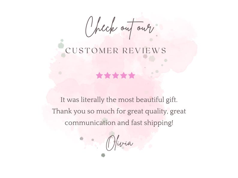 May include: A graphic with text that reads "Check out our CUSTOMER REVIEWS." The text is on a pink watercolour background with five pink stars. The text below reads "It was literally the most beautiful gift."