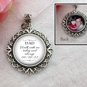 May include: Silver charm with a white background and black text that reads "DAD Walk with me today and always 09/28/22". The back of the charm has a photo of a man and a girl.
