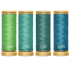 May include: Four spools of Gütermann sewing thread in shades of green and blue, labelled 7850, 7745, 7760, and 6934. Each spool features a tan base and top with the text 100 m - 110 yds/vgs printed clearly on the bottom of the spool.