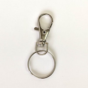 May include: Silver key chain with a swivel clasp and a round ring.